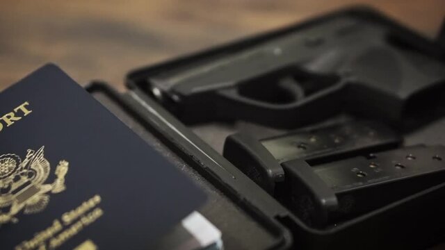 Gun and passport panning shot in foam hardcase
