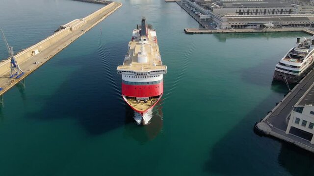 Aerial view of a Cruise liner ship leaving Marseille Marina, France - tilt, drone shot