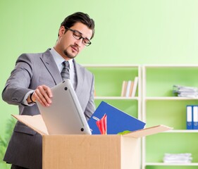 Male employee collecting his stuff after redundancy