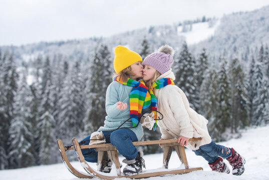 Children kissing. Outdoor kids little boy and girl kiss on winter outdoors.