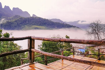 wooden balcony ,Baan on the mountain, a beautiful mountain and sea of fog on a rainy day