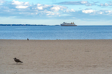 The beach on Long Island Sound at New London with a ferry on the horizon