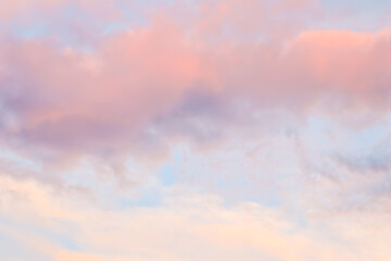Background of blue sky with white and pink clouds in sunset. High quality photo