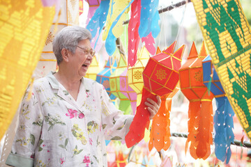 asian old elderly elder woman with hanging festive paper lantern