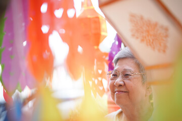 Fototapeta na wymiar asian old elderly elder woman with hanging festive paper lantern