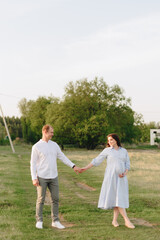 Young heterosexual pregnant couple in an outdoor park