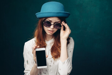 fashionable woman in blue hat with phone in hands communication technology