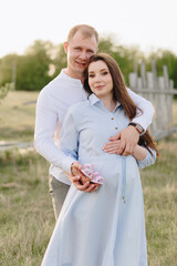 Young heterosexual pregnant couple in an outdoor park