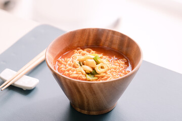 The red ramen in a wooden bowl.