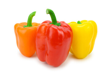 Three multi-colored sweet bell peppers, placed vertically