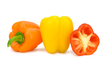 Two whole sweet bell peppers and a half turned cut to the camera