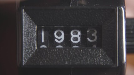 The number on a tally counter turning from 1979 to 1984