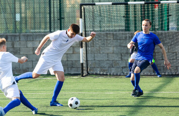 Youth football player kicking ball in direction of goal