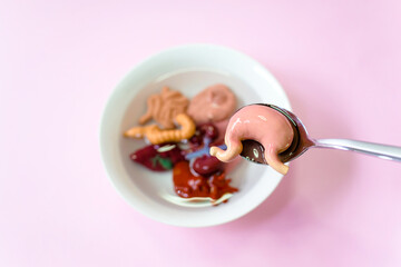 Human stomach in the spoon and human internal organs with soup in white bowl, Every food you eat has an effect on your body.