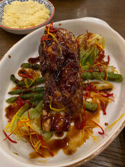 Barbecue Chuck Beef Ribs served with Vegetables in Plate at Restaurant.
