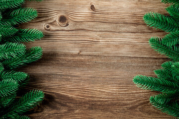 Top view of green branches on dark wooden background, Banner, copy space, Christmas and New Year background concept.