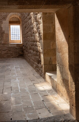 Wall of an old palace with window openings and beautiful shadows