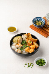 Yong tau foo , yong tau fu or Liong Tahu (In Indonesia). is a Hakka Chinese cuisine consisting primarily of tofu filled with ground meat mixture or fish paste.