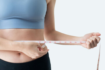 Heathy woman measuring her waist with tape measure isolated on white background, with clipping path
