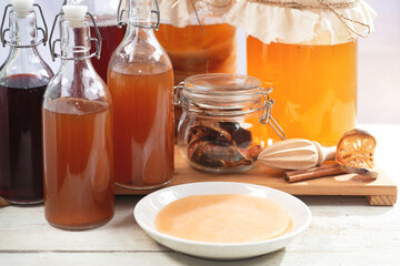 Homemade fermented raw Kombucha tea, healthy natural probiotic flavored drink, variety of Kombucha drink, Scoby tea mushroom to start the fermentation process to make Kombucha