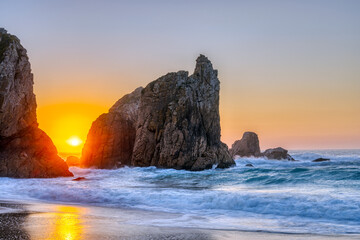 Beautiful sunset on a rocky beach at the portuguese atlantic coast