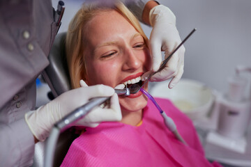 Woman performing a dental procedure on a patient