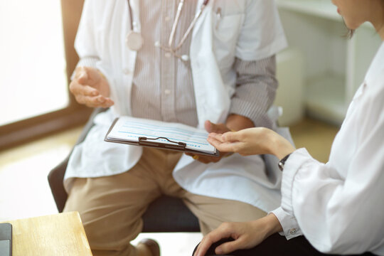 Cropped image of A doctor and a patient discuss treatment options
