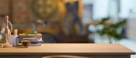 Classic wooden table with stationery, decor and copy space over blurred living room background