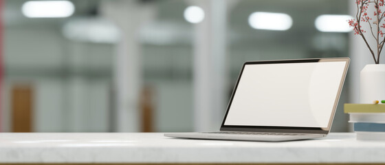 Laptop computer blank screen mockup on marble white table.