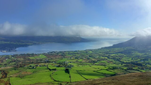 Carlingford Lough, Louth, Ireland, October 2021. Drone pulls east towards the Tain Way away from Bavan and Omeath while touching the low-hanging clouds.