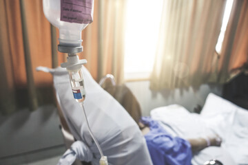 Closeup of saline solution drip for patient in the hospital ward.