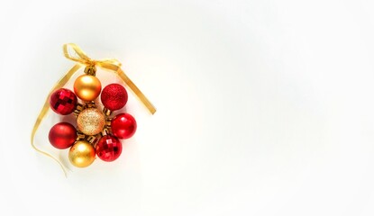 Christmas balls in round. Gold and red christmas ball with ribbon bow on white background. New Year background. Christmas balls close up picture.