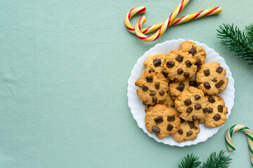 Christmas cookies with chocolate chips on blue textile background, space for text