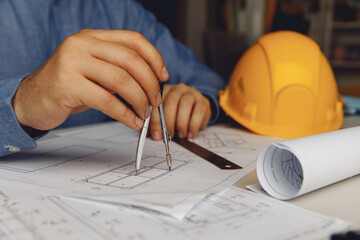 Architect engineer hand hold compass, writing and drawing architectural project