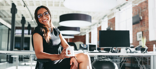 Businesswoman having a coffee break at work