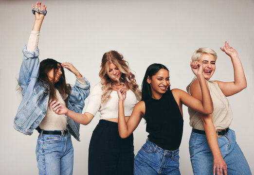 Group of female friends dancing in a studio