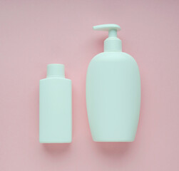 Coronavirus prevention hand sanitizer gel and alcohol hand sanitizer gel bottle on  pink background. Top view.