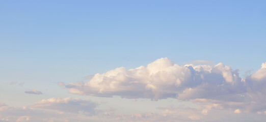 Naklejka na ściany i meble Beautiful cumulus clouds on sunny day at golden hour painted in pastel pink with sun. Banner