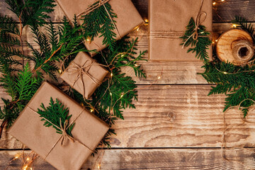 Boxes packed with kraft paper and natural twine on a wooden background.Eco-friendly material.Christmas and New Year.