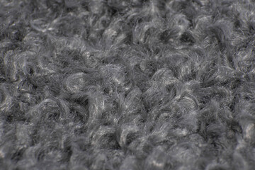 close-up of curly fur. gray faux fur. eco wool lamb. gray wool