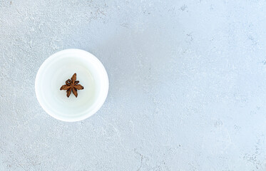 Anise on a white plate, on a gray background. High quality photo
