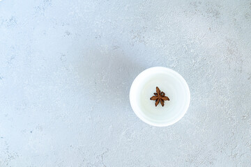 Anise on a white plate, on a gray background. High quality photo