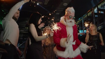 Happy young people, Santa Claus dancing at costume New Year celebration party - Powered by Adobe