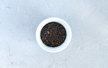Fototapeta na wymiar black tea on a white plate, on a black background. High quality photo