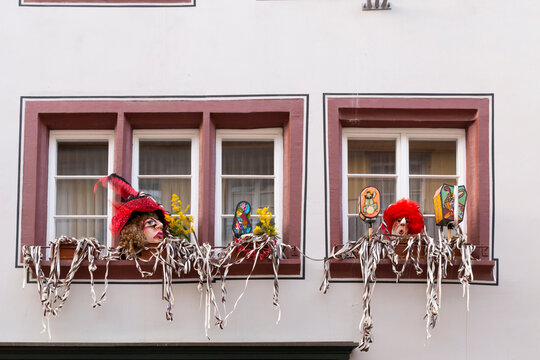 Basel, Switzerland - February 21. Carnival windows decoration with masks and colorful garlands