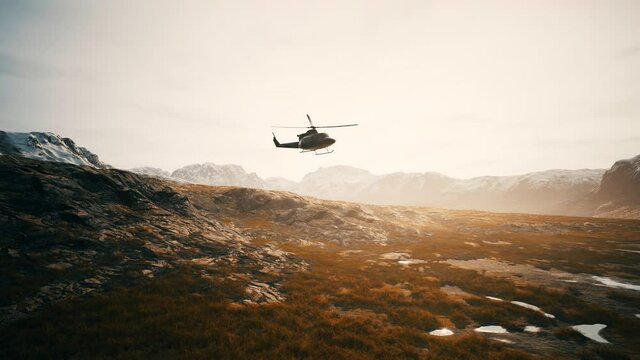 slow motion Vietnam War era helicopter in mountains