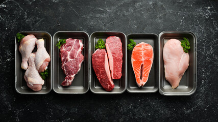 Set of fresh raw meat and fish in plastic boxes: veal, salmon steak, chicken, pork. Banner for the...
