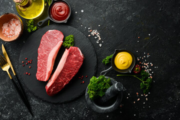 Raw fresh marble meat Black Angus Steak Ribeye on a dark background. Top view. Raw meat.