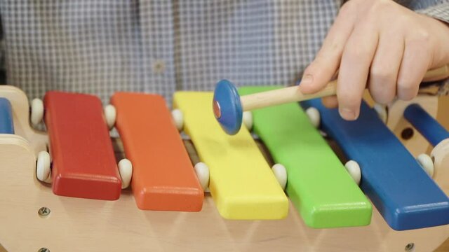 Teaching a child to play the metallophone