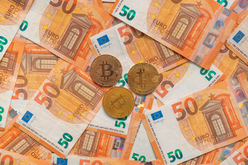 Bitcoin coins and Euro banknotes